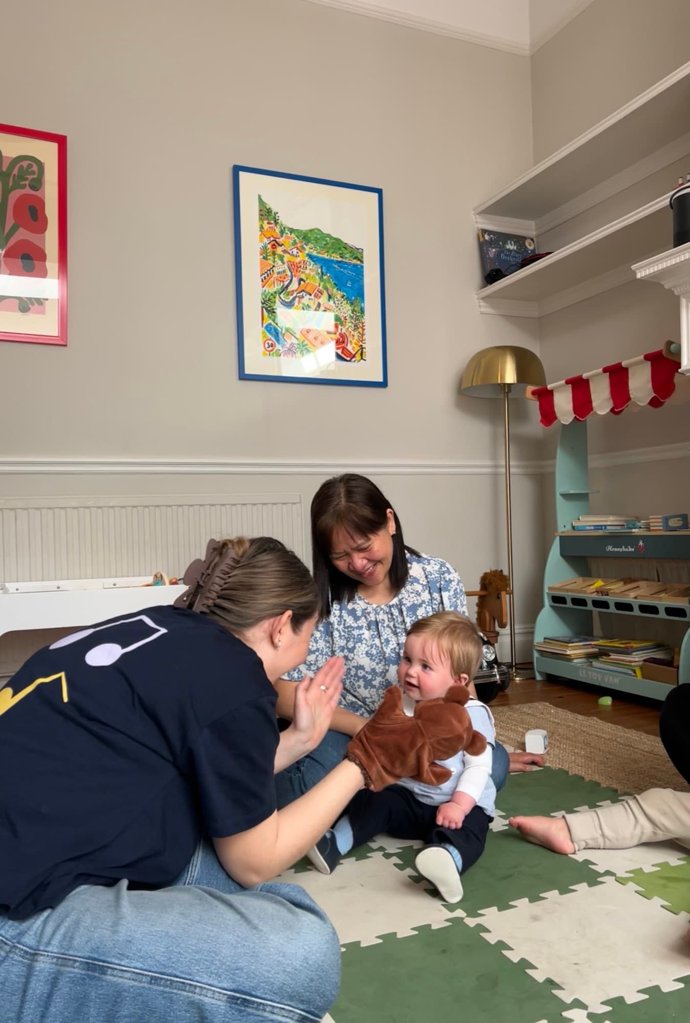High-fiving a baby during a music session